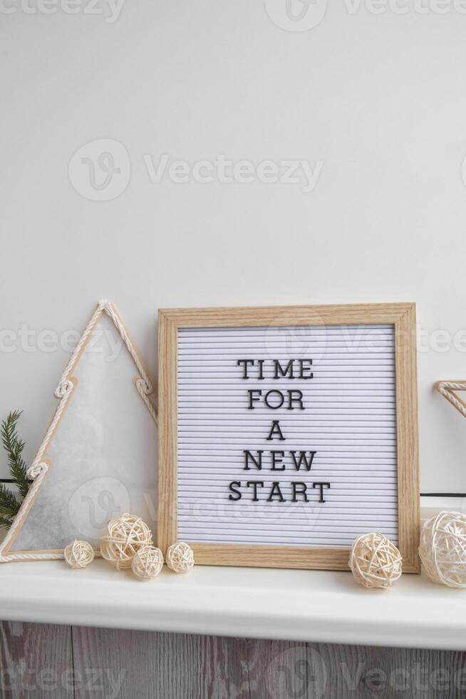 Letter board with inspirational message TIME FOR A NEW START with natural zero waste homemade Christmas decor. Happy new year promises resolutions concept. Self growth and personal development photo