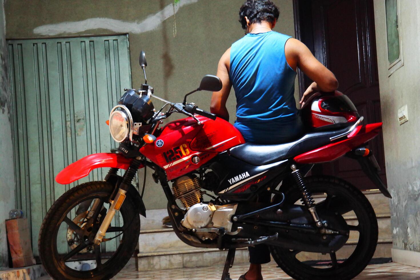 a man is sitting on a motorcycle in DHA Lahore on September 21, 2024 photo