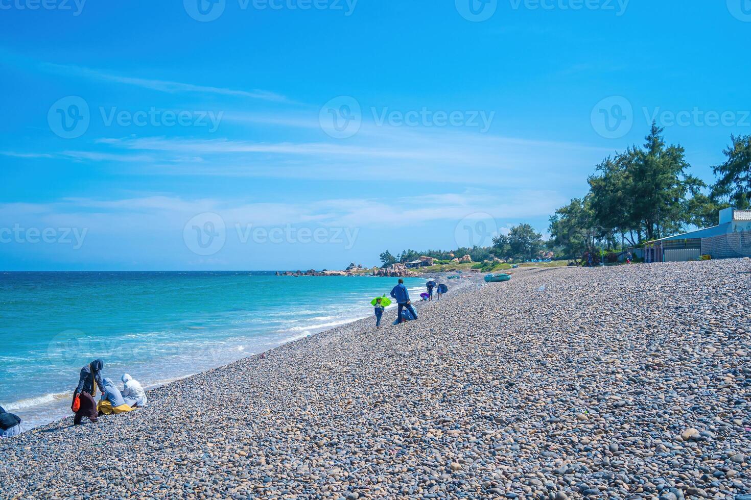 Bay Mau beach at Mui Ne, Binh Thuan. Sea stone pebble background. Abstract nature background with pebble stones. Full frame shot of multicolored pebbles. Close-up. photo