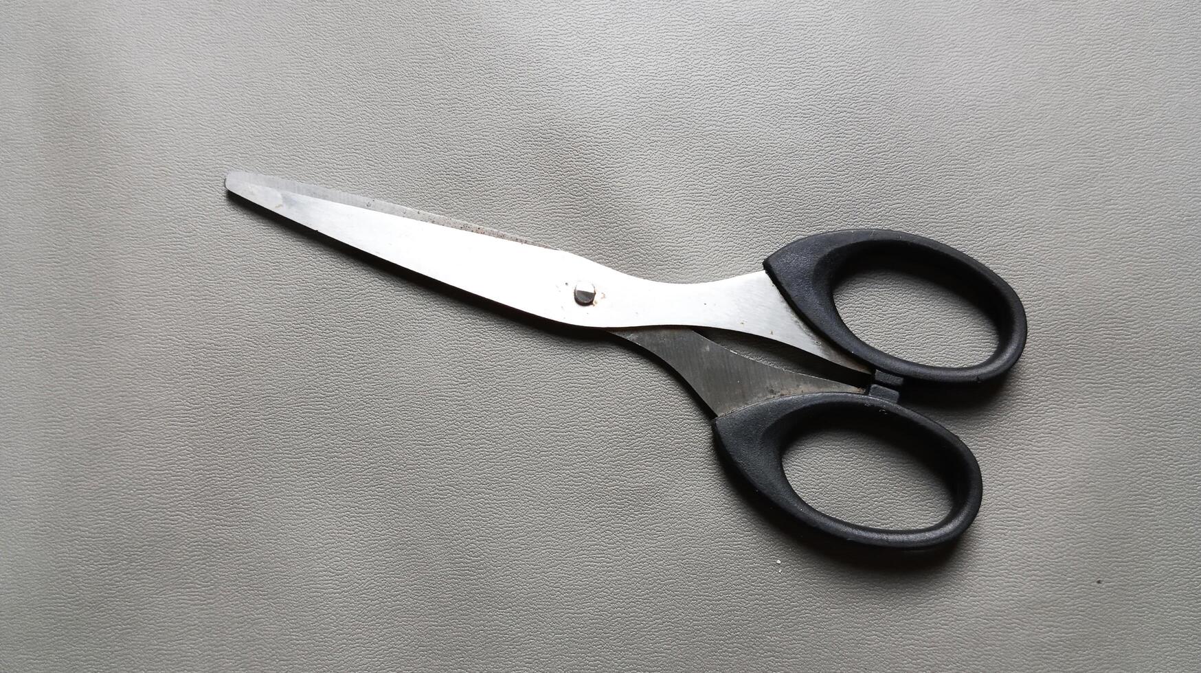 Scissors on a gray background. photo