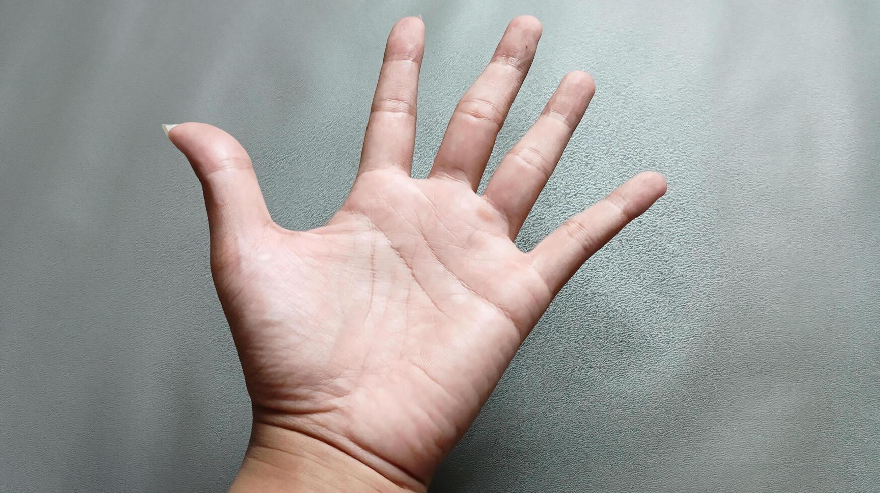 Man's hand, Man's palm on gray background photo