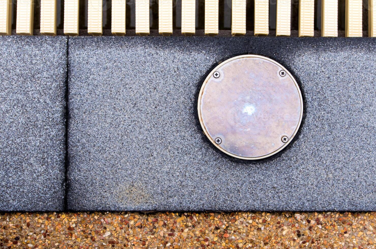 The surface texture on the joint of the different non slip flooring and the metal cover of service hole beside the pool photo