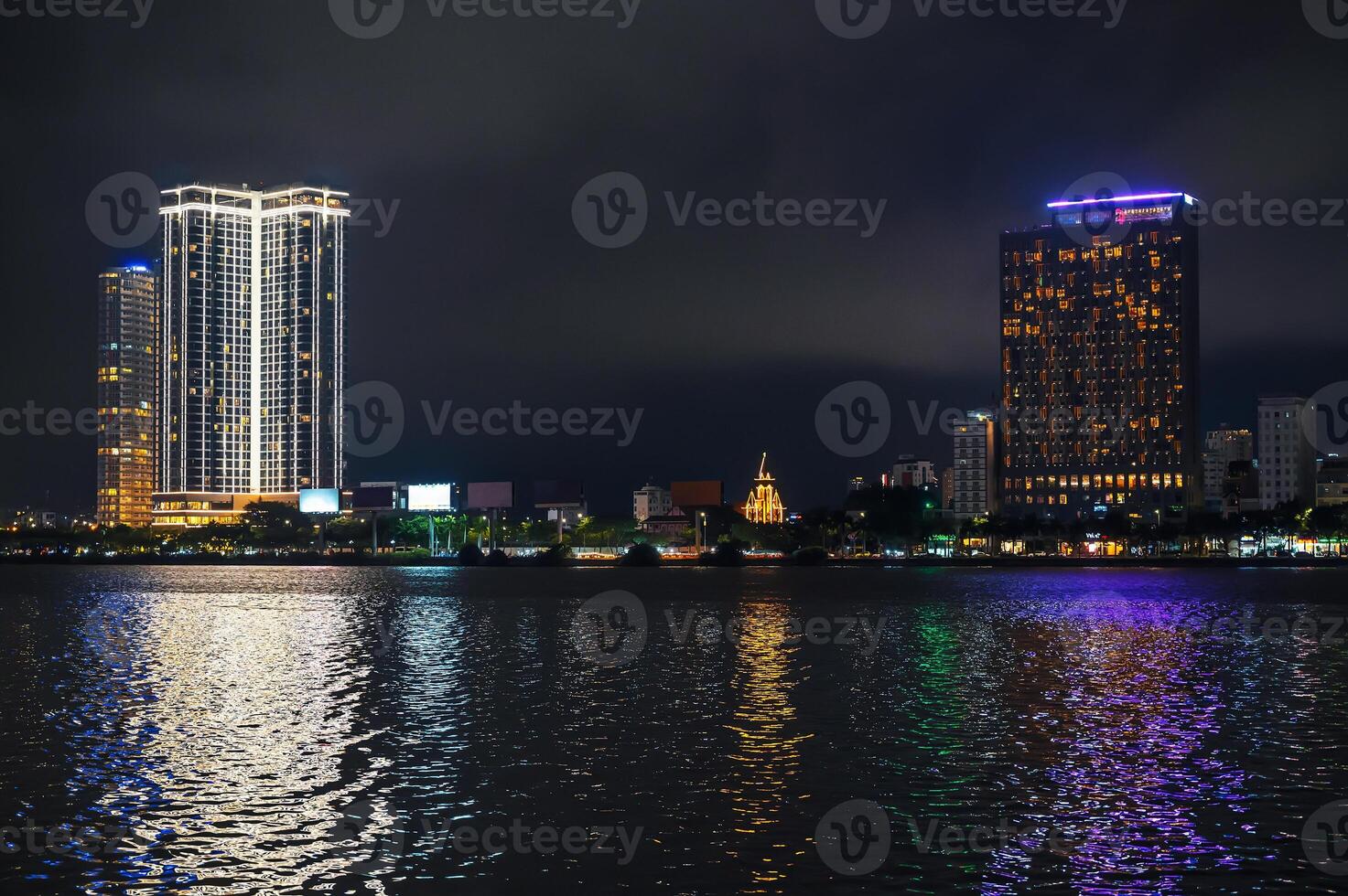 Night panorama of Da Nang city with Han River embankment and hotels skyscrapers on the shore at night in Vietnam photo