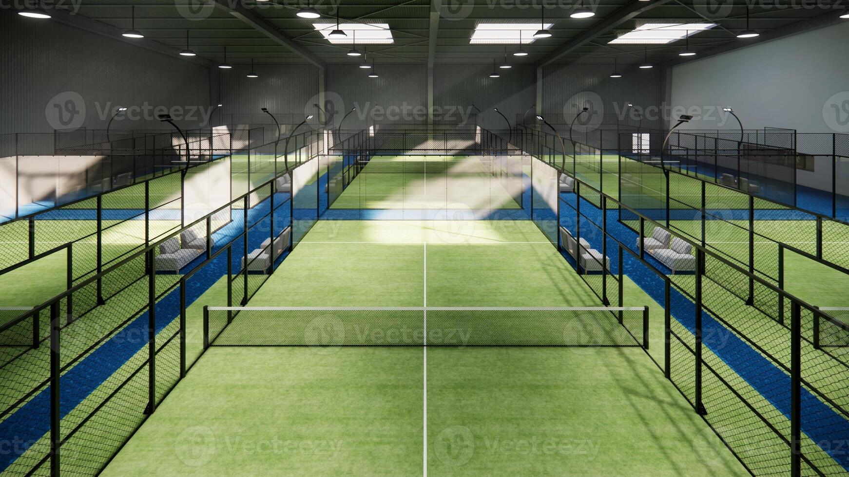 aerial view on a padel court with greenflooring and glass that serve as walls inside hangar building photo