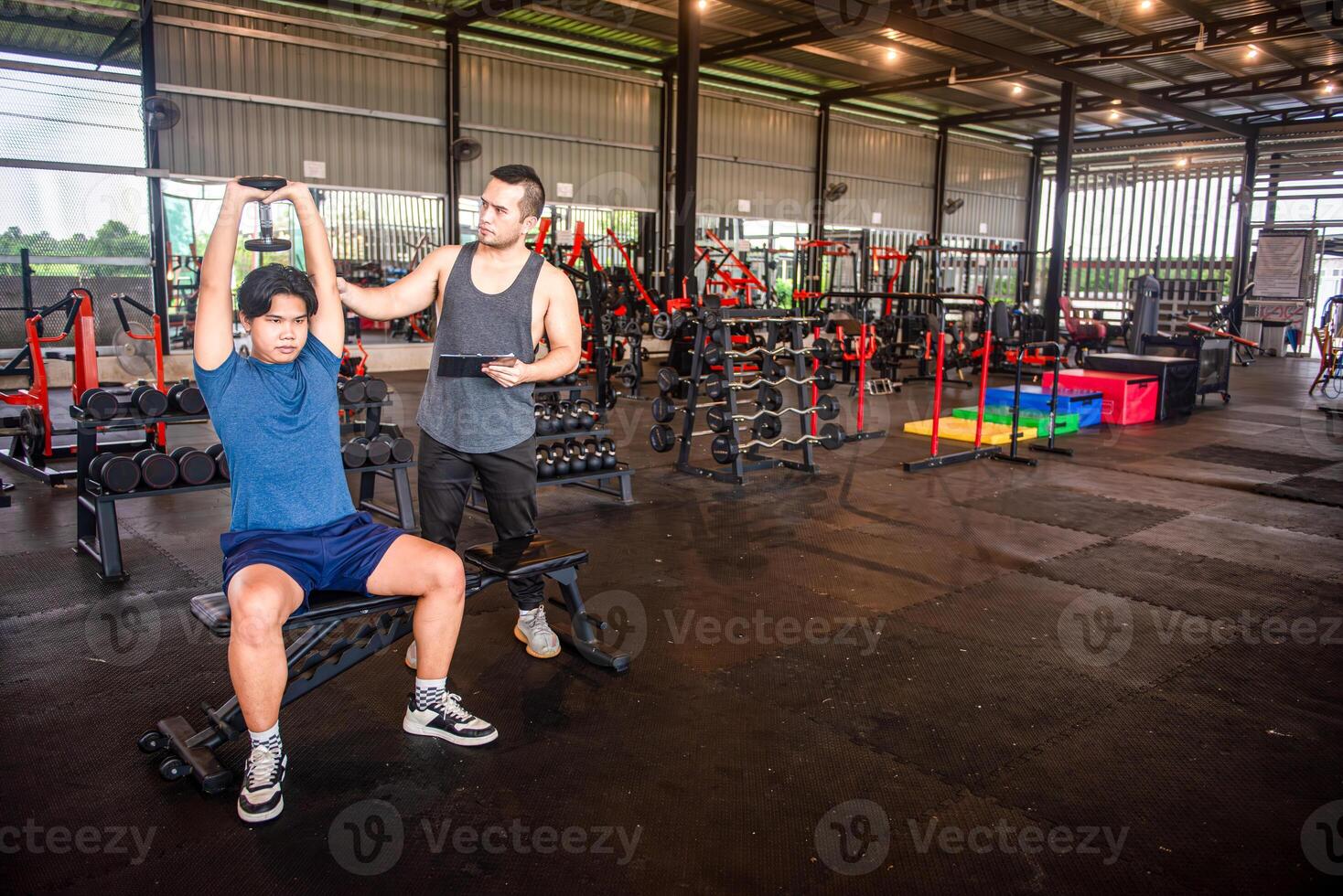 male trainer is teaching correct exercise postures to customers who come to use the services at the fitness center. photo
