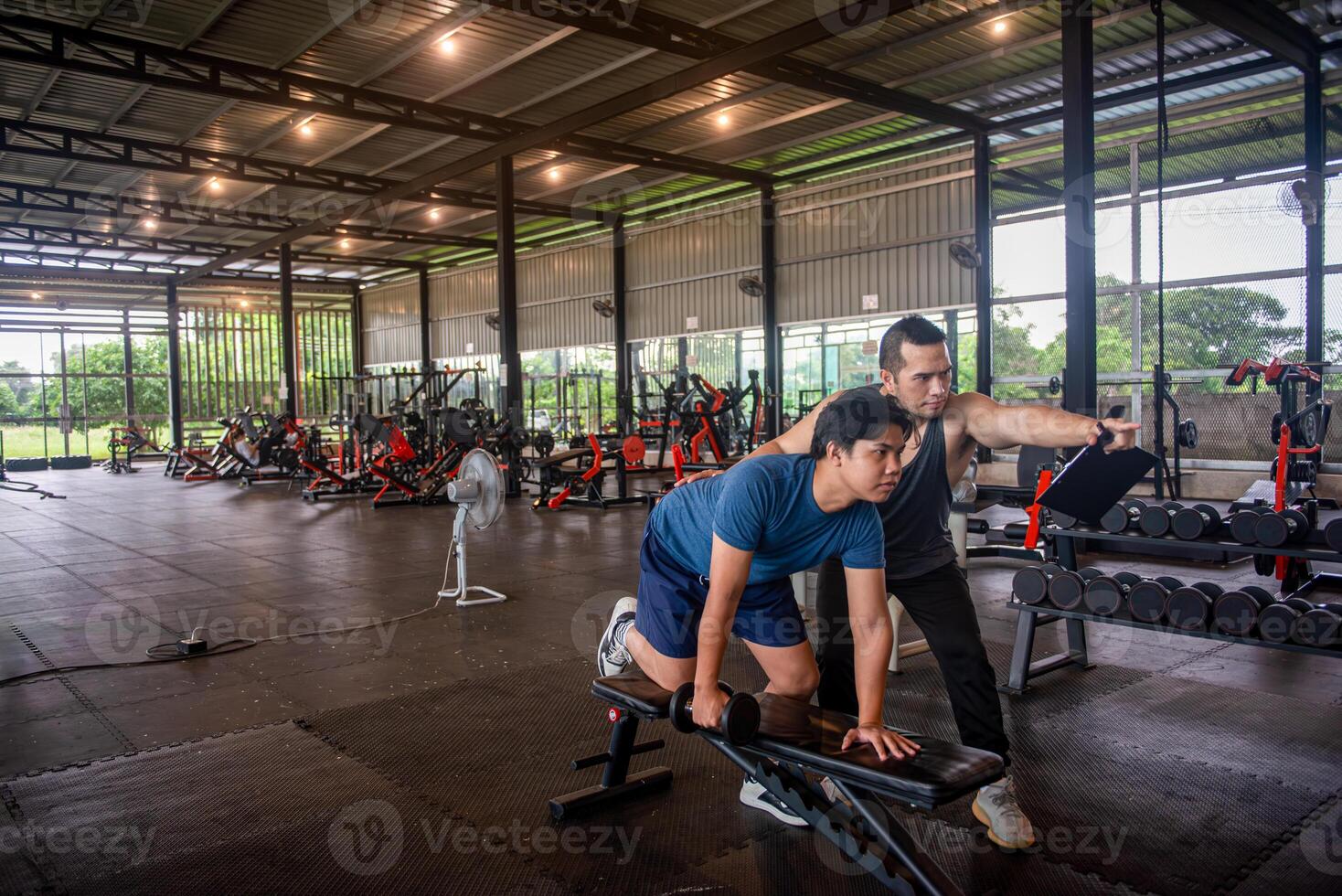 male trainer is teaching correct exercise postures to customers who come to use the services at the fitness center. photo