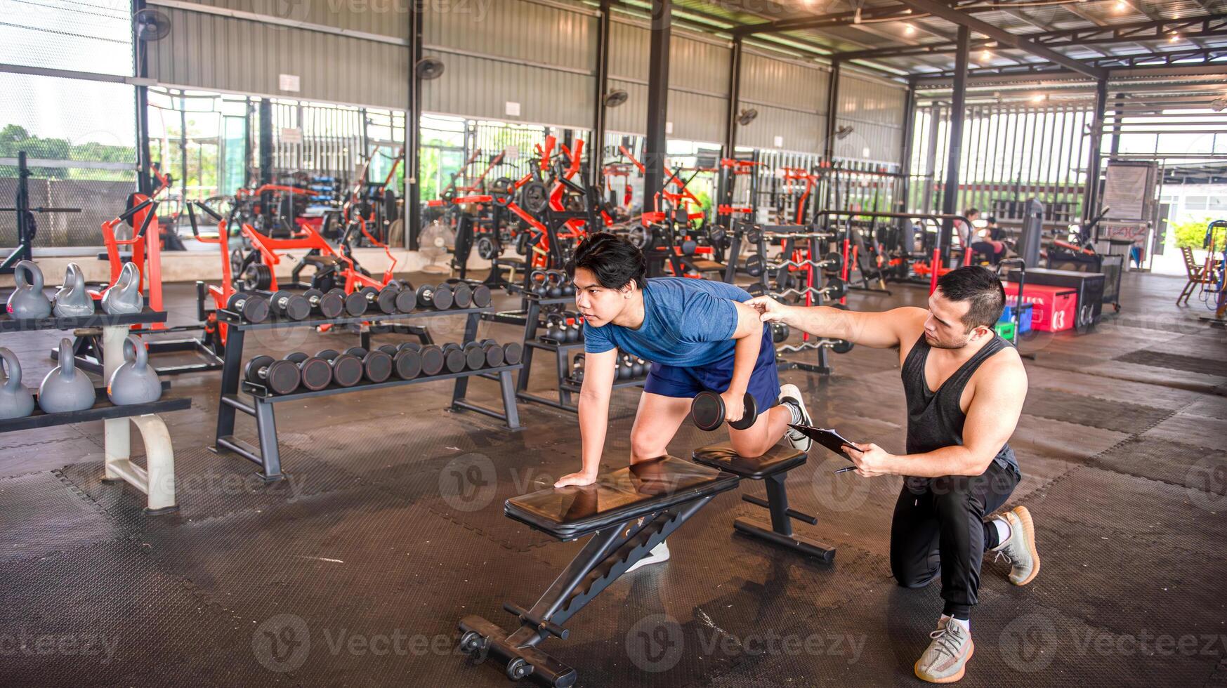 male trainer is teaching correct exercise postures to customers who come to use the services at the fitness center. photo