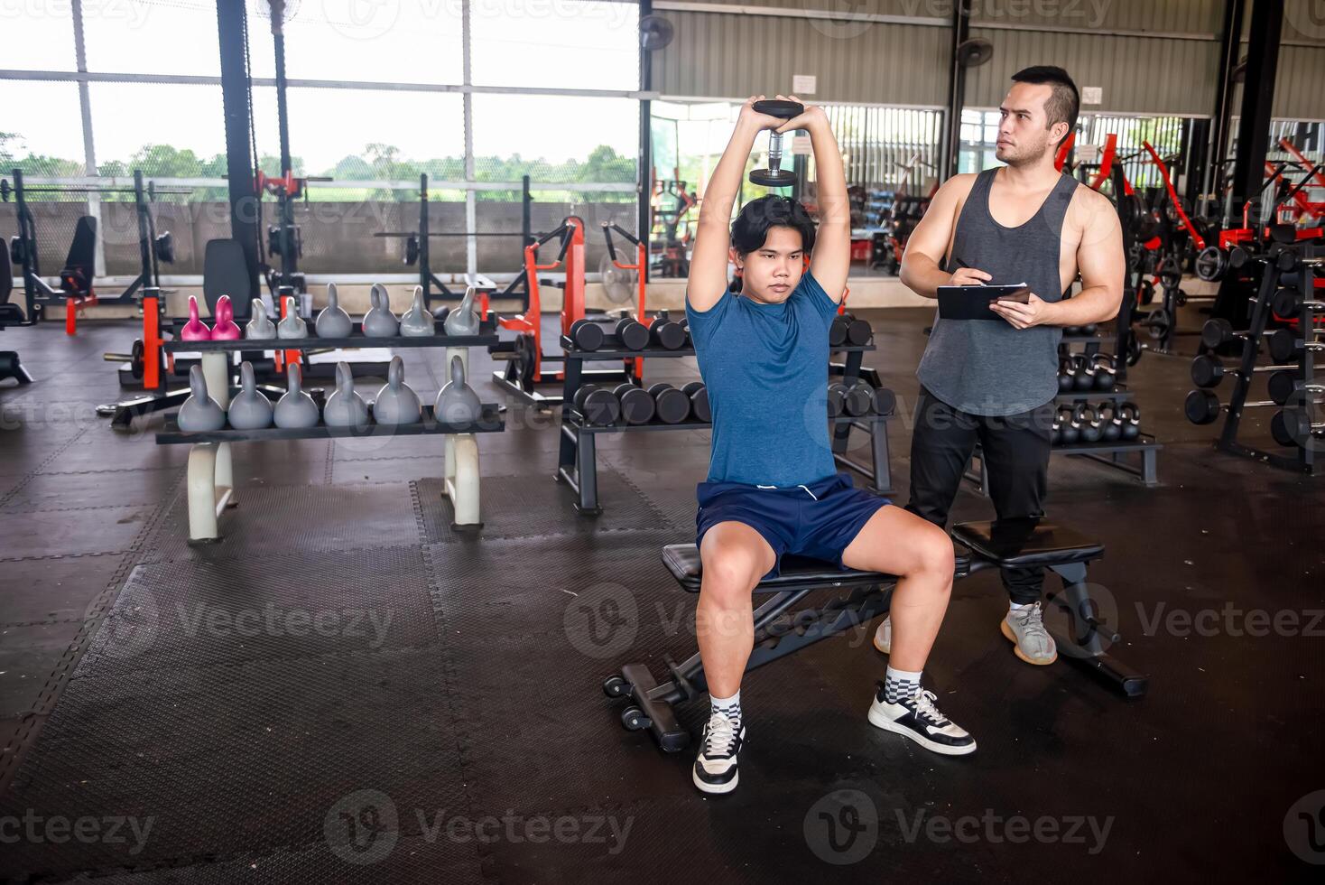 male trainer is teaching correct exercise postures to customers who come to use the services at the fitness center. photo