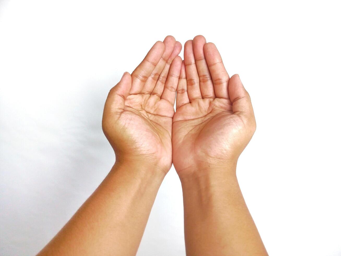 Religion. Man with open palms praying on white background, closeup photo