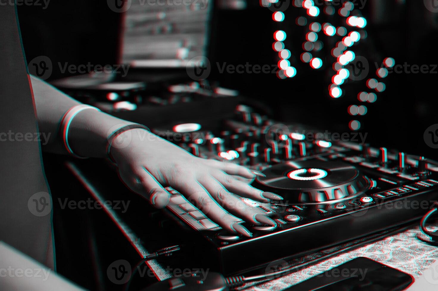 hand of a DJ girl on the background of a music controller mixer photo