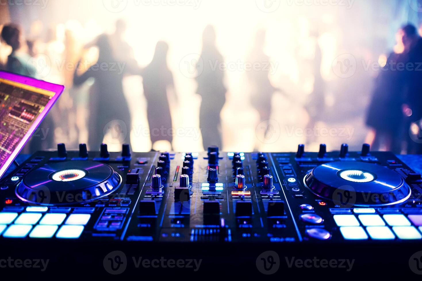 music controller DJ mixer in a nightclub at a party photo