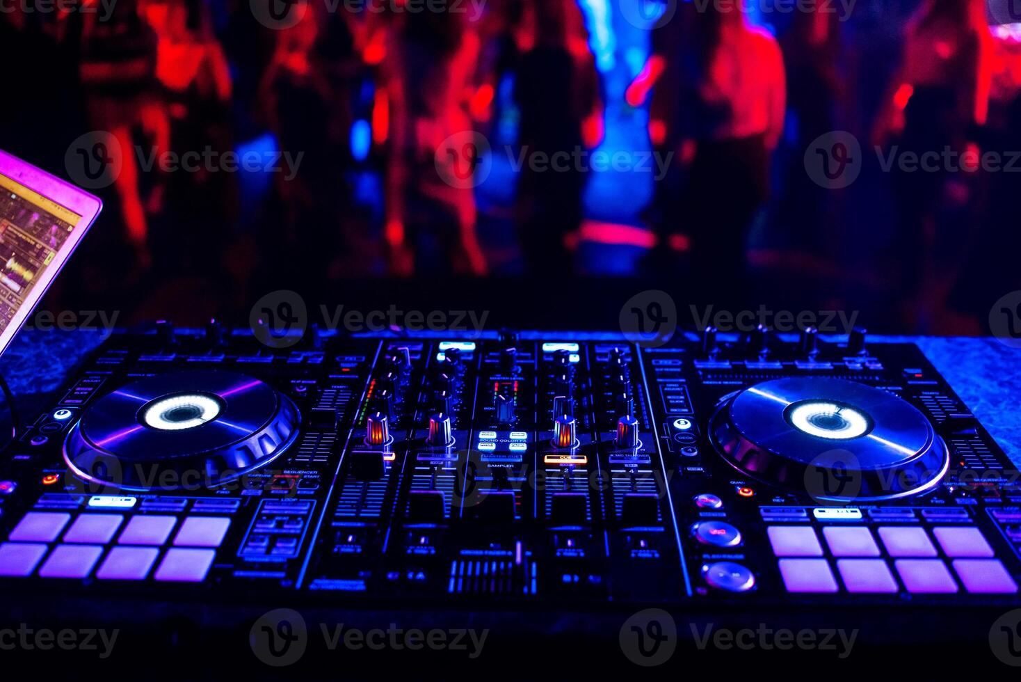 music controller DJ mixer in a nightclub at a party photo