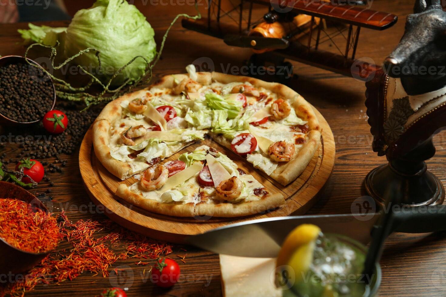 Pizza With Shrimp, Lettuce, and Tomato on Wooden Board photo