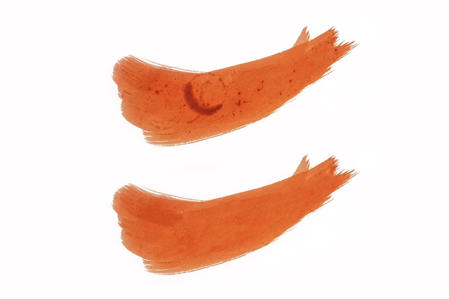 Set of two orange acrylic paint strokes isolated over the white background photo