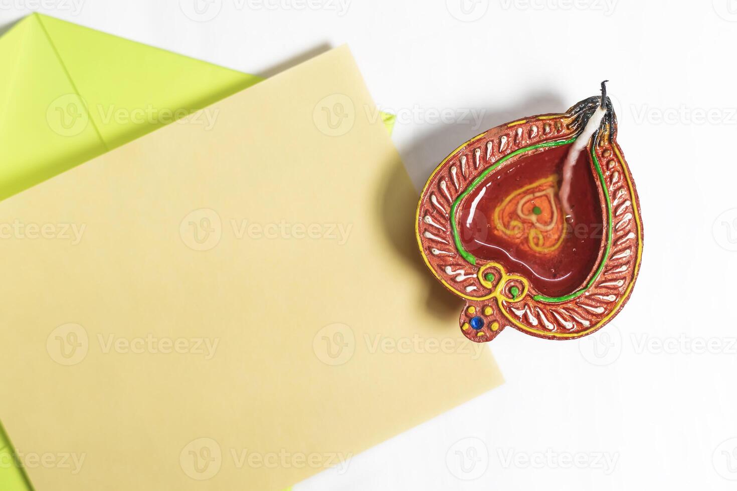 Diwali greeting card with festive diya lamp on white background. photo