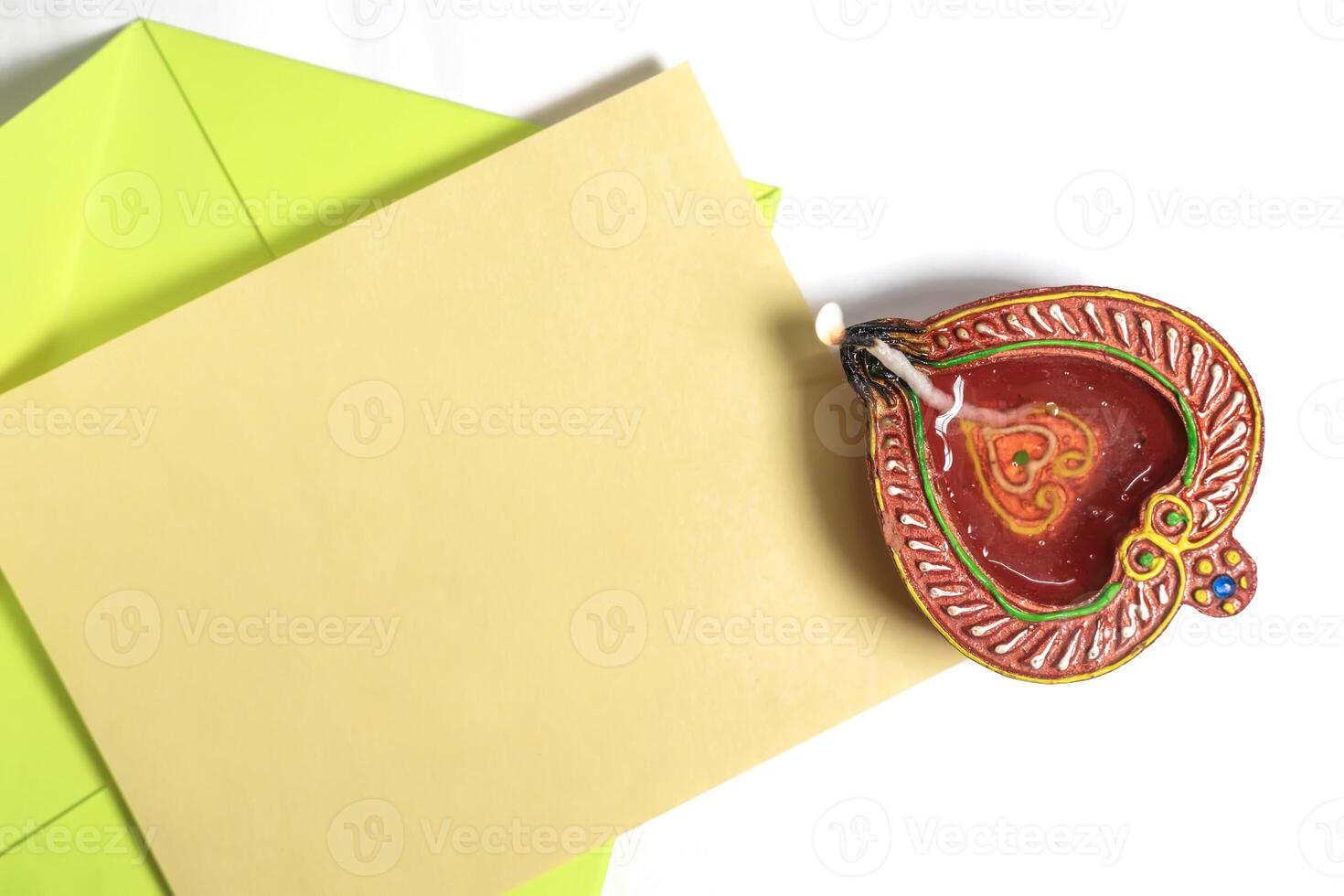 Happy Diwali celebration greeting card and clay diya lamp isolated on white background. photo
