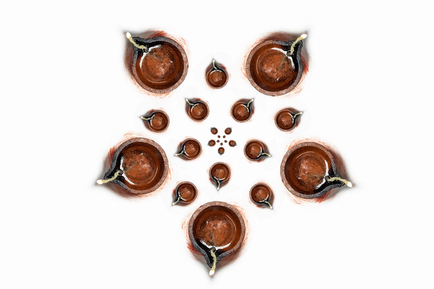 Happy Diwali - Top view of traditional clay oil lamps isolated on white background for Hindu festival celebrations. photo