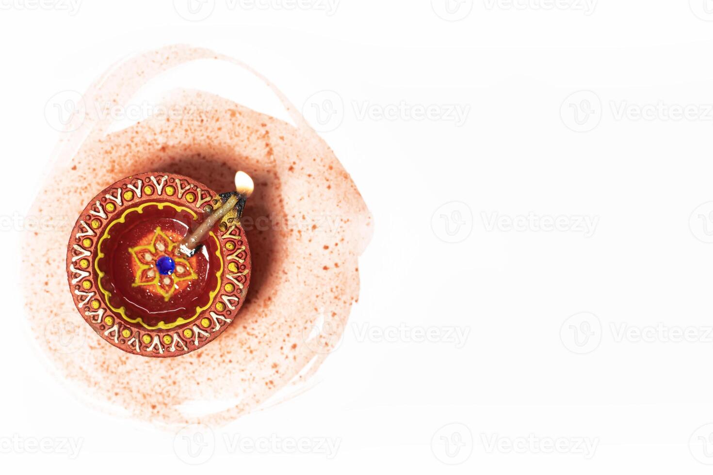 Happy Diwali - Close up of diwali diya lamp on white background with space for text. Hindu festival of lights. photo