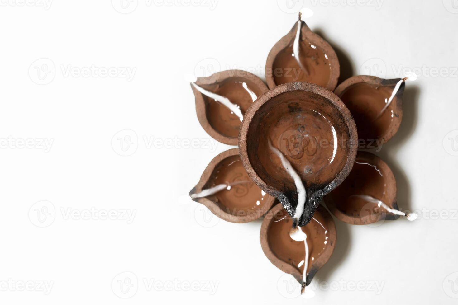 Traditional Diwali Arrangement with Earthen Diyas Forming a Floral Pattern for Festival of Lights. photo