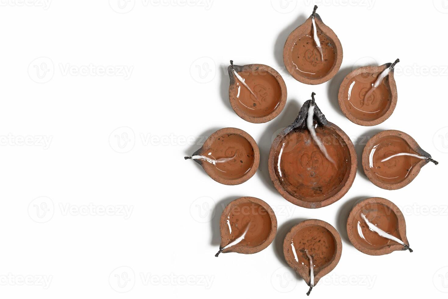 Hindu traditional clay diya arrangement for Diwali celebration on white background with copy space for text. photo