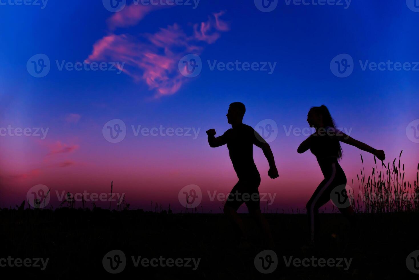 silhouettes of men and girls running in the morning photo