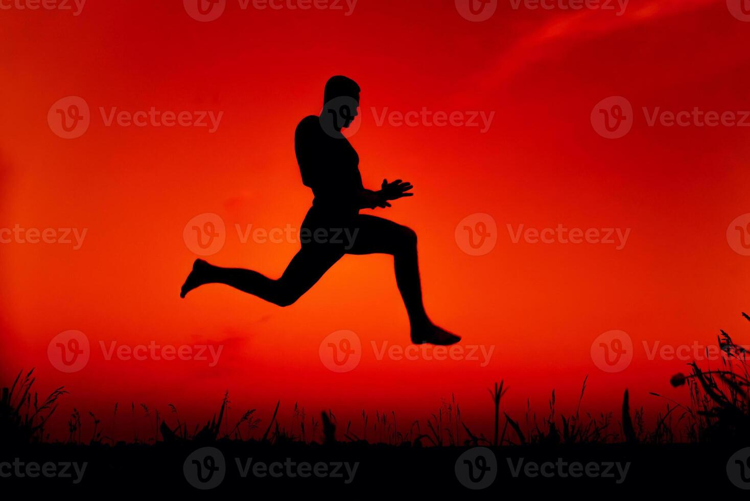 silhouette of a man jumping high in nature in summer photo