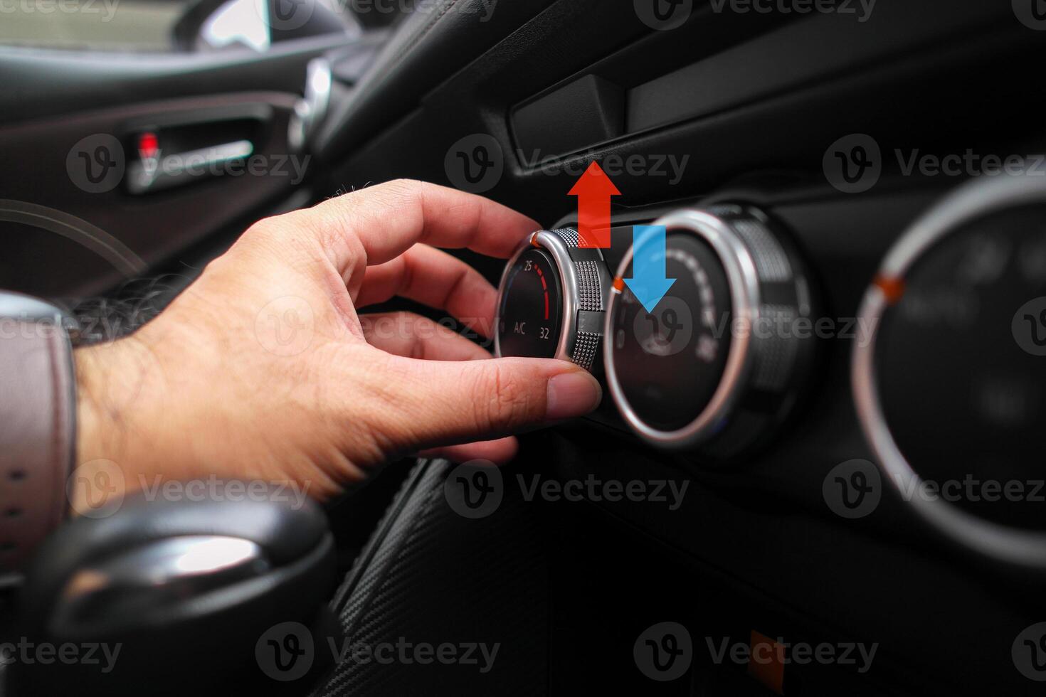 Adjusting the temperature of air conditioning inside a car , The driver uses his hands to turn the knob to adjust the air conditioning temperature while driving photo