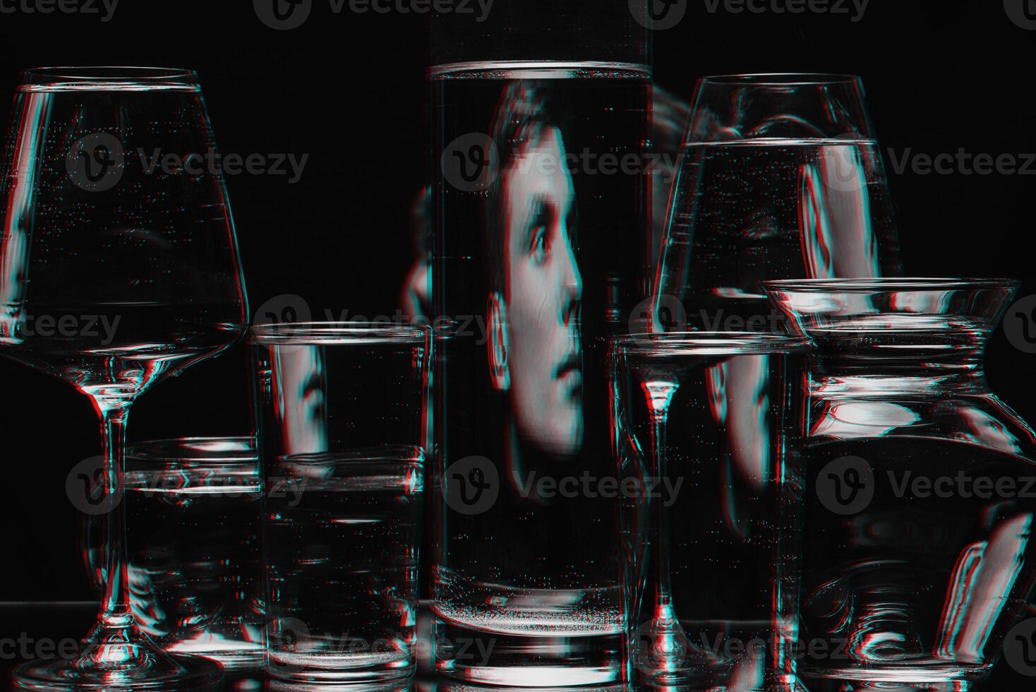 strange abstract portrait of a man through the glass of the tank with water with the reflections and distortions photo