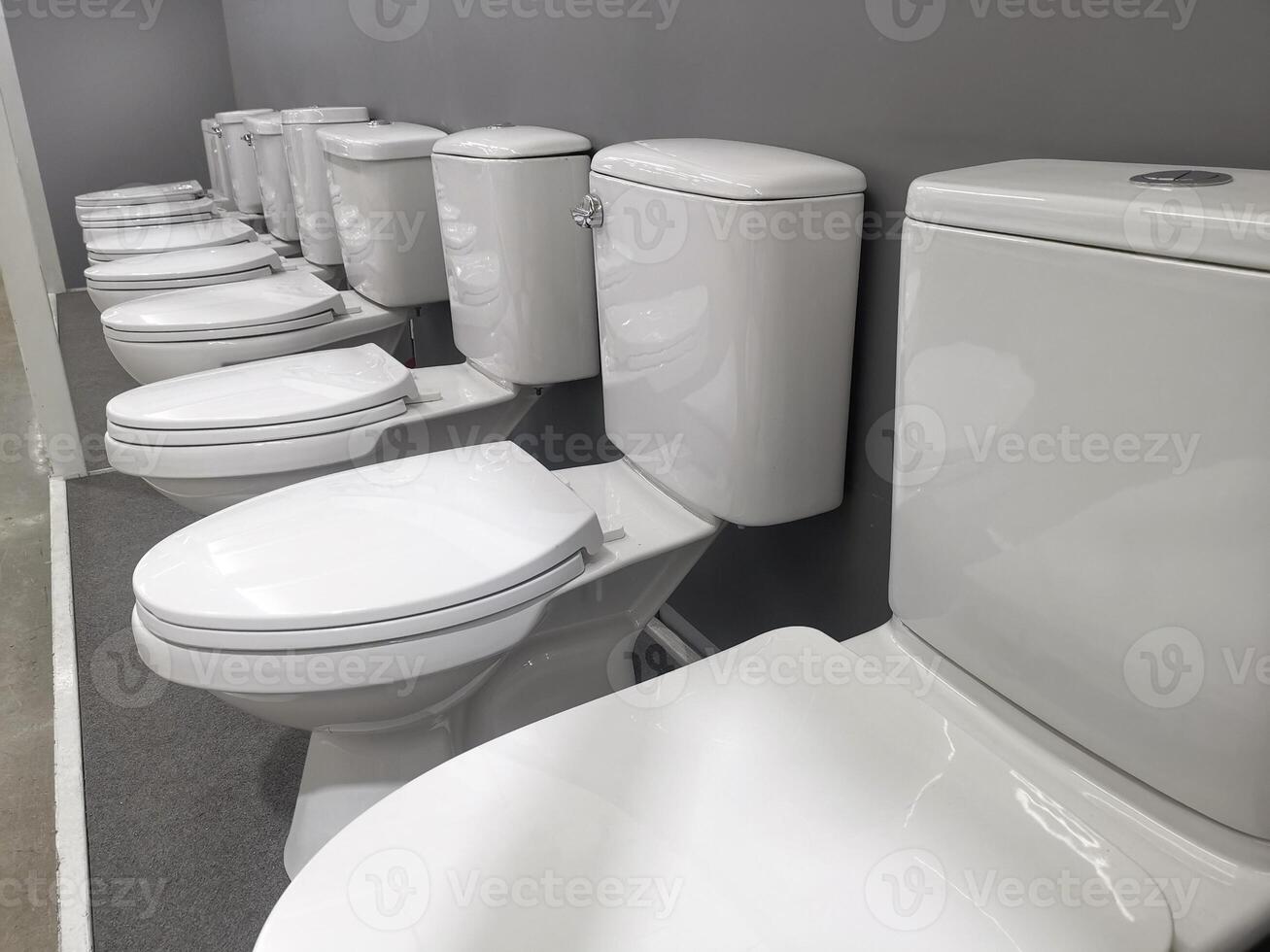 New modern toilet in the plumbing store. Samples of modern sanitary ware for the toilet photo