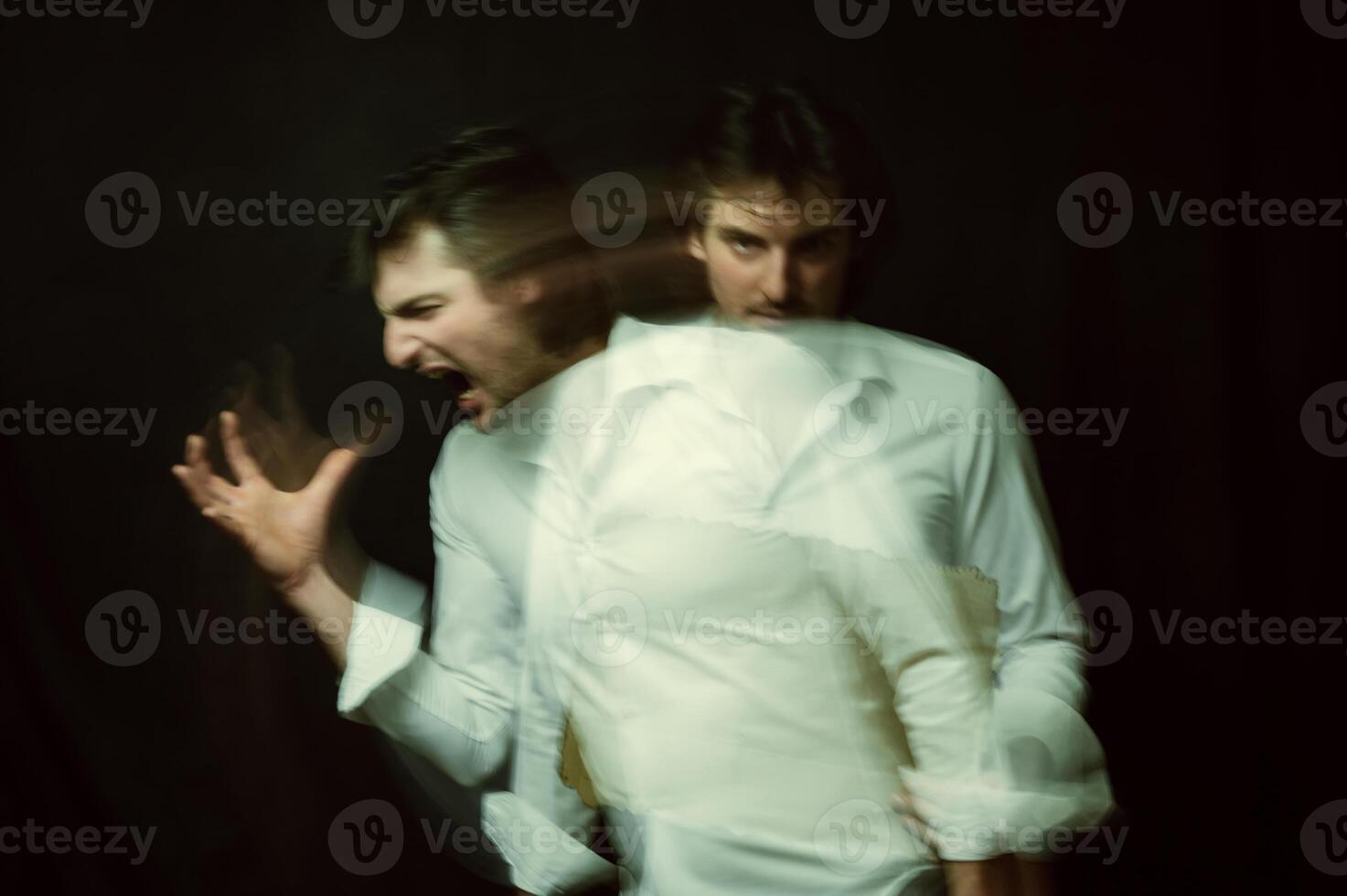 schizophrenic portrait of a psychopathic man with mental disorders in a white shirt photo