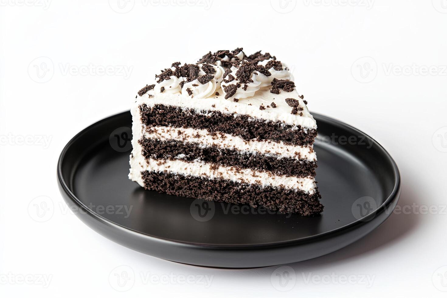 A single slice of chocolate cake with white frosting and chocolate sprinkles on a black plate against a white background. photo