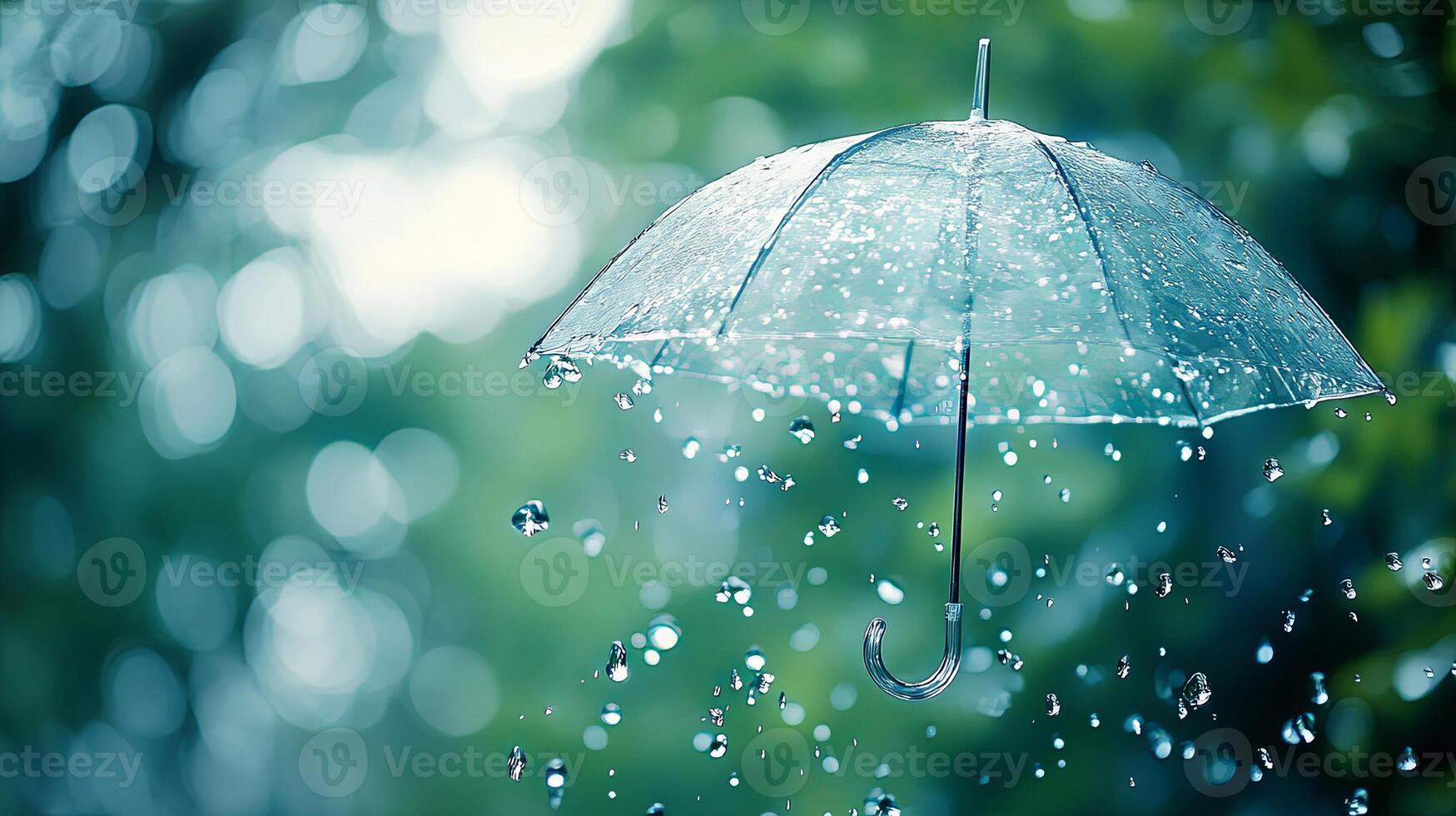 A transparent umbrella with raindrops falling from it, in front of a green bokeh background. photo
