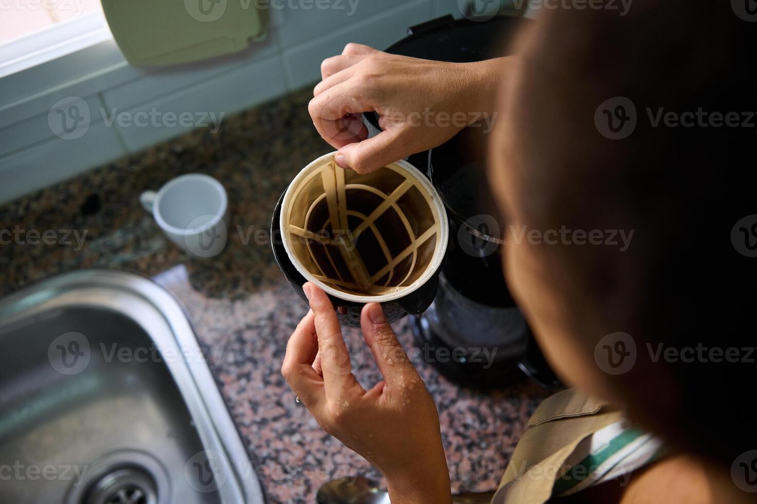 Preparing a coffee maker in a home kitchen setting photo