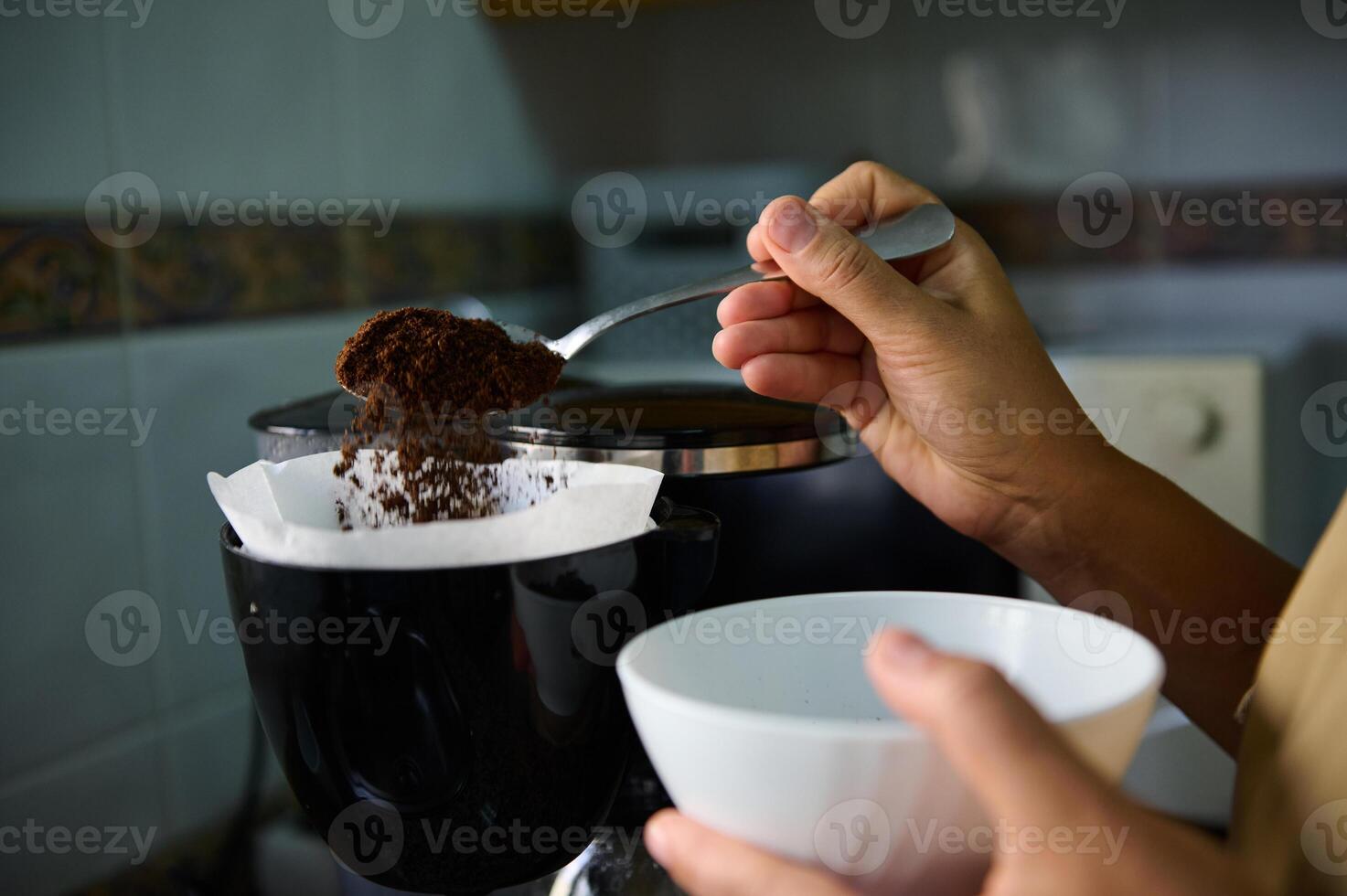 Person preparing fresh coffee with a filter in kitchen photo