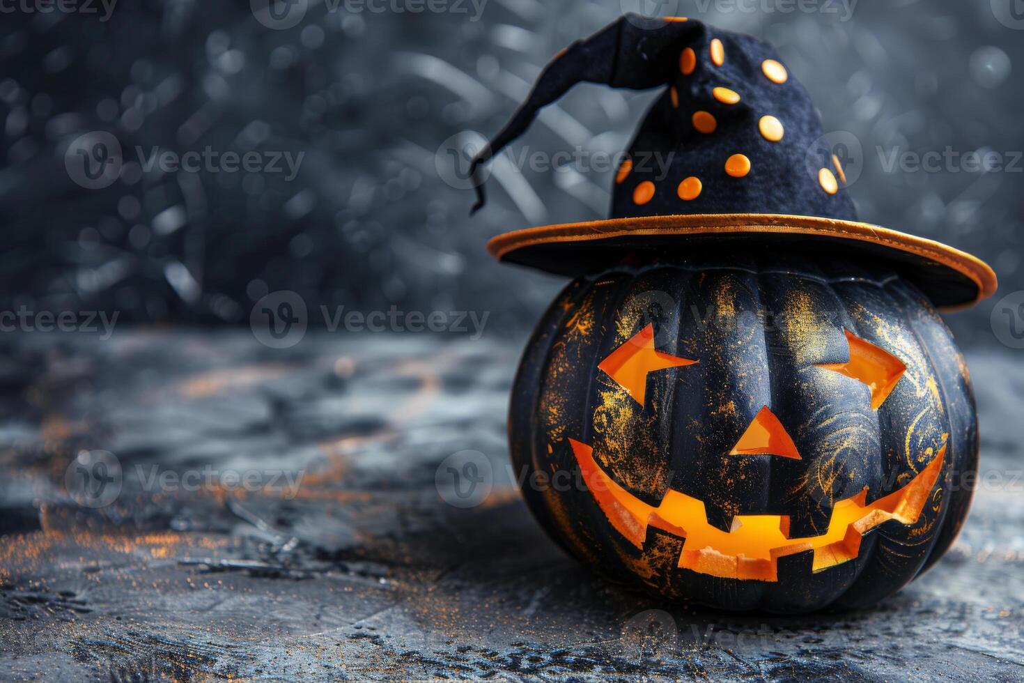 Black Halloween pumpkin with a glowing carved face and a witch hat with orange polka dots photo