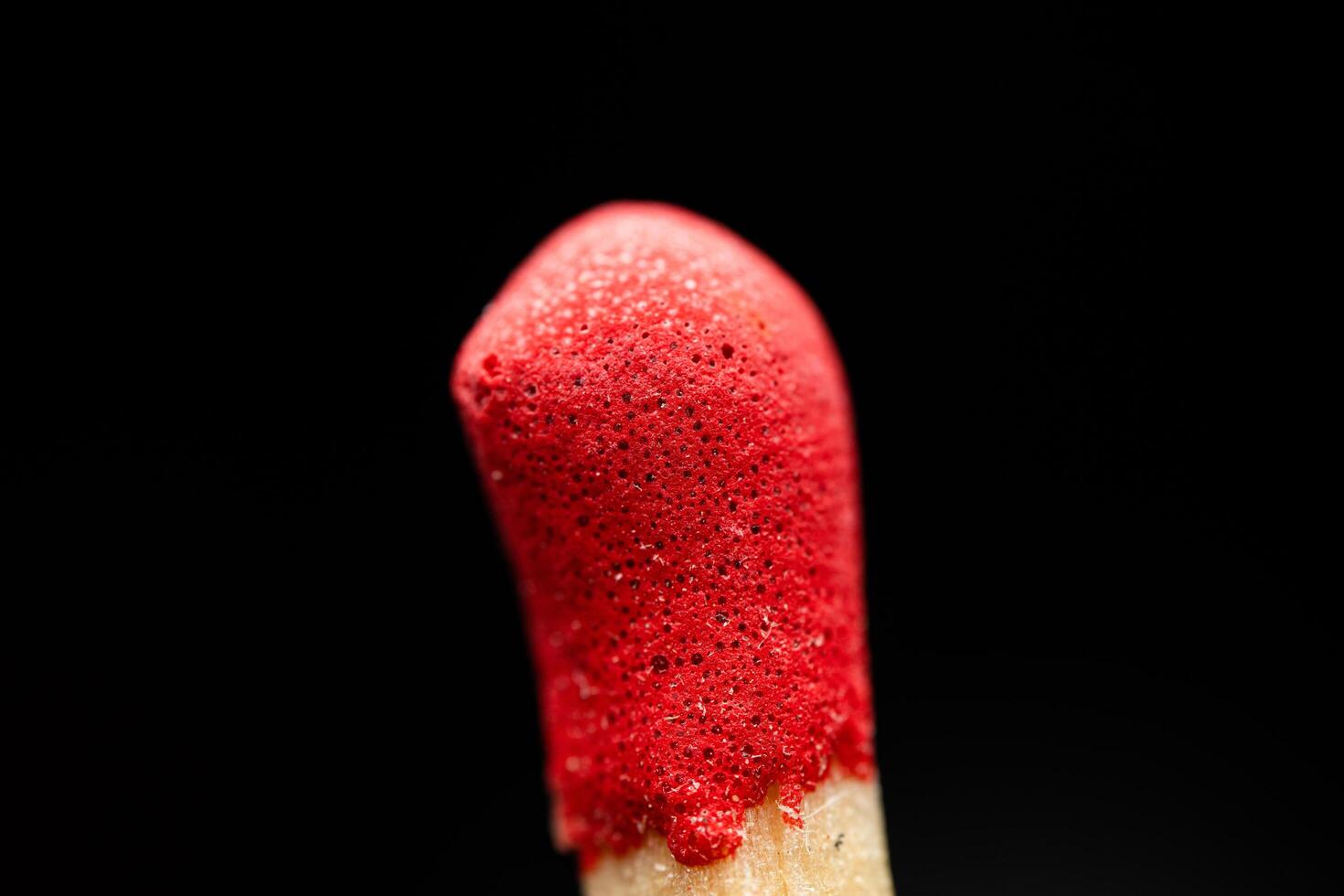 A matchstick with red paint on it photo