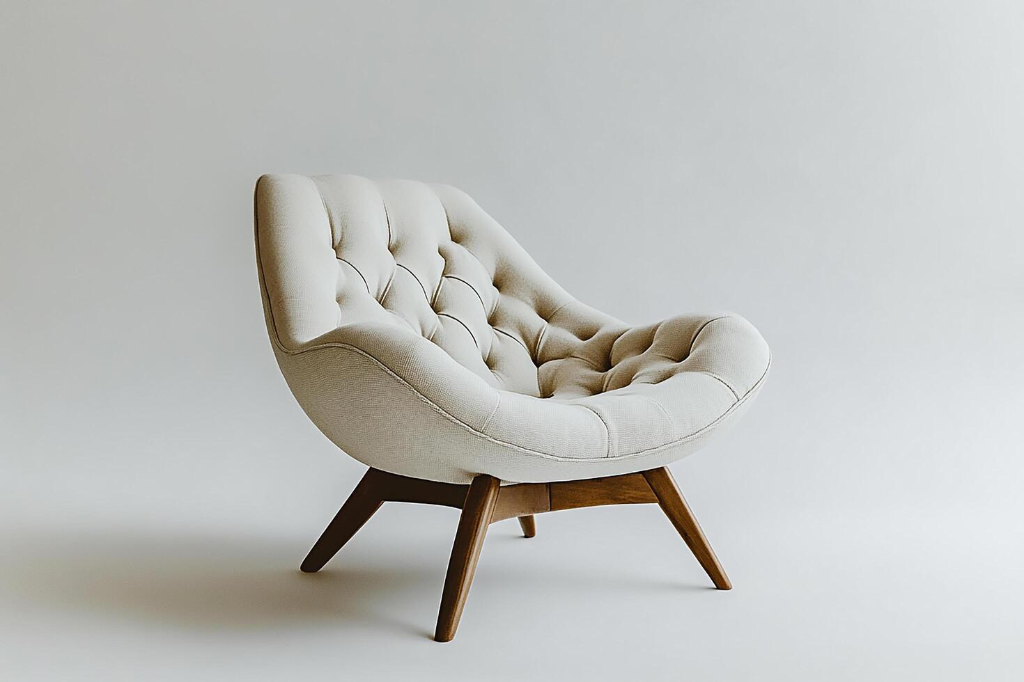 Chic modern chair with button tufts and angular wooden legs isolated photo