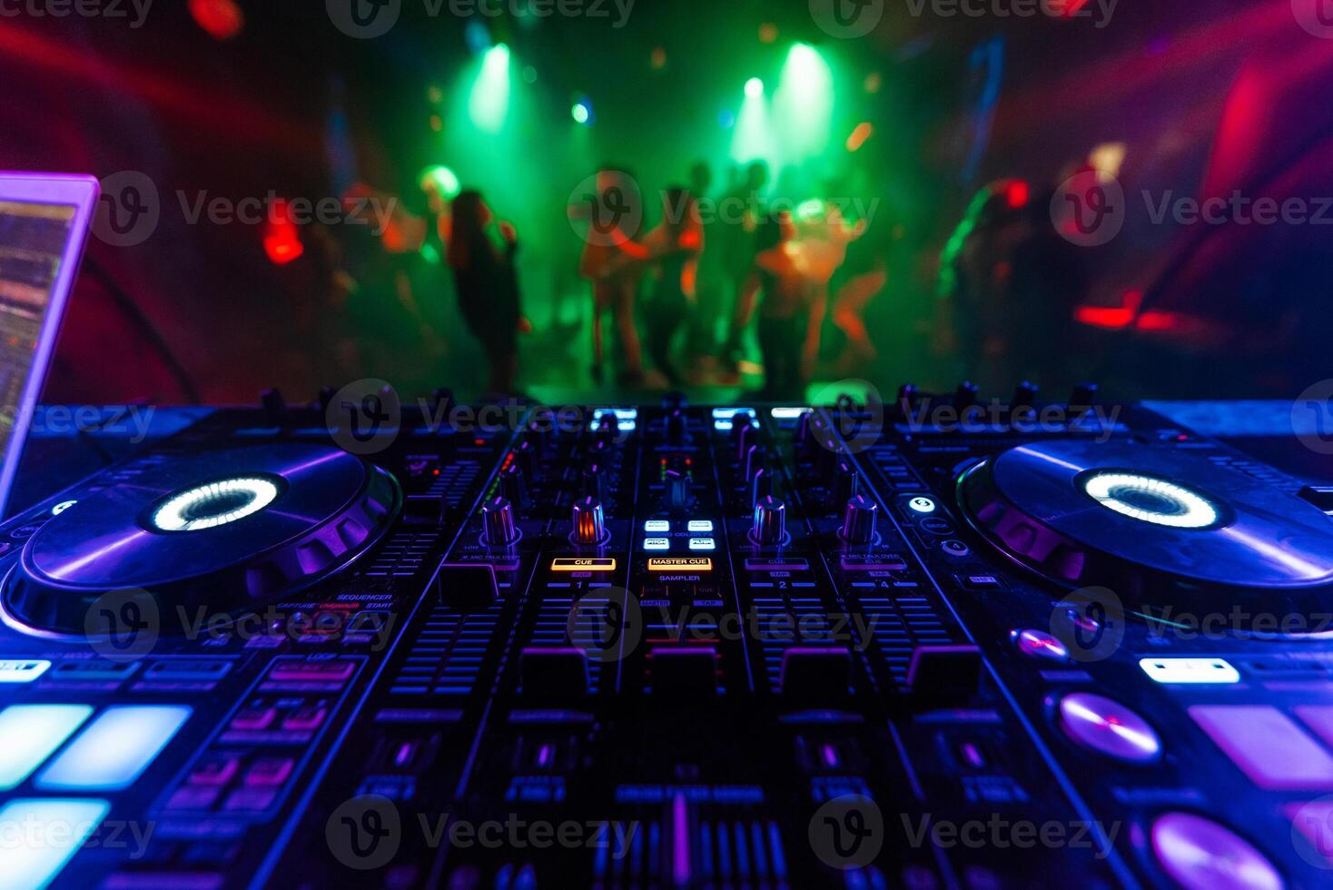 professional DJ mixer controller for mixing music in a nightclub photo