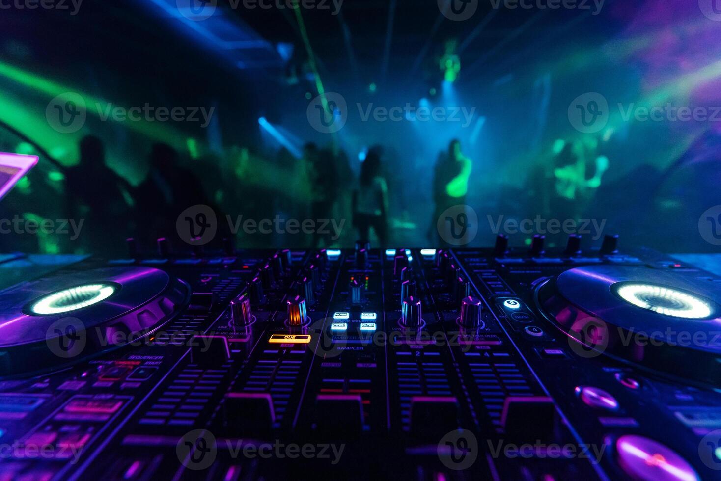 professional DJ mixer controller for mixing music in a nightclub photo