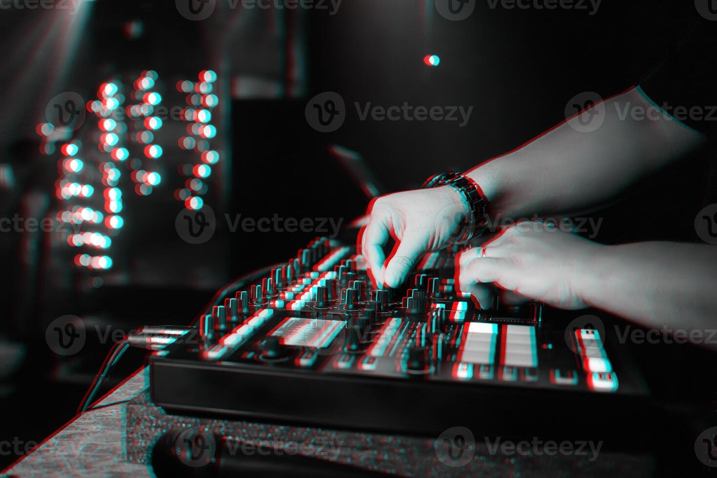 male DJ mixes electronic music on a professional music controller photo