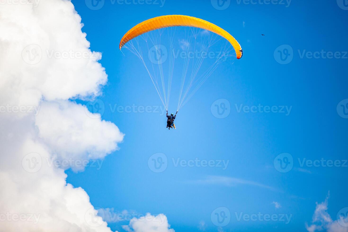 People paragliding over the beautiful mountains of the Antioquia department in Colombia. Tandem Paragliding. Extreme sport concept. photo