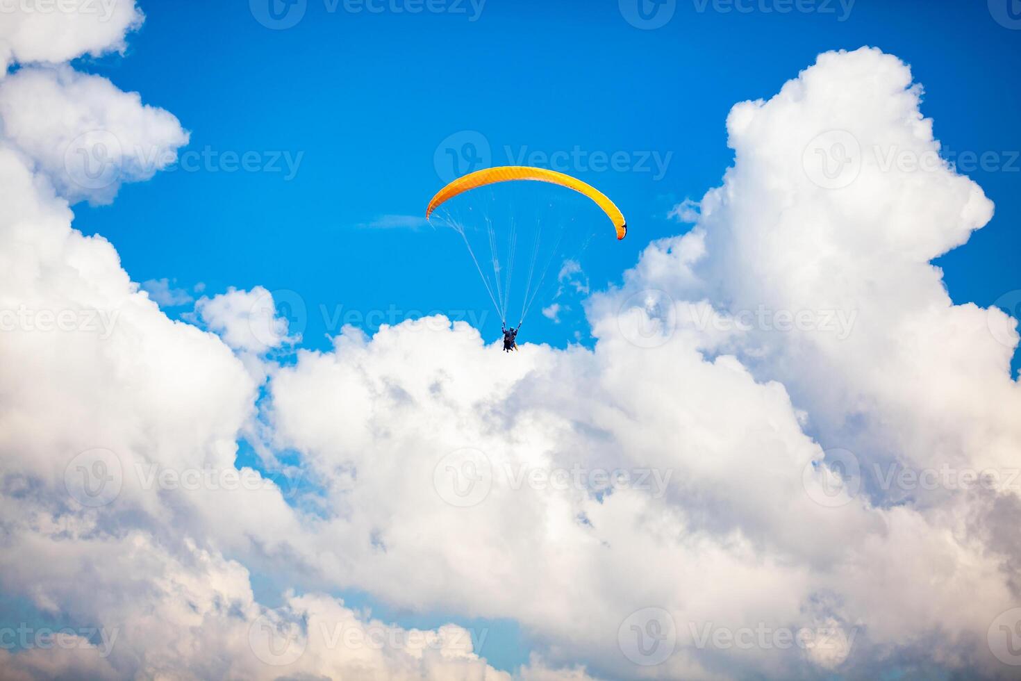 People paragliding over the beautiful mountains of the Antioquia department in Colombia. Tandem Paragliding. Extreme sport concept. photo