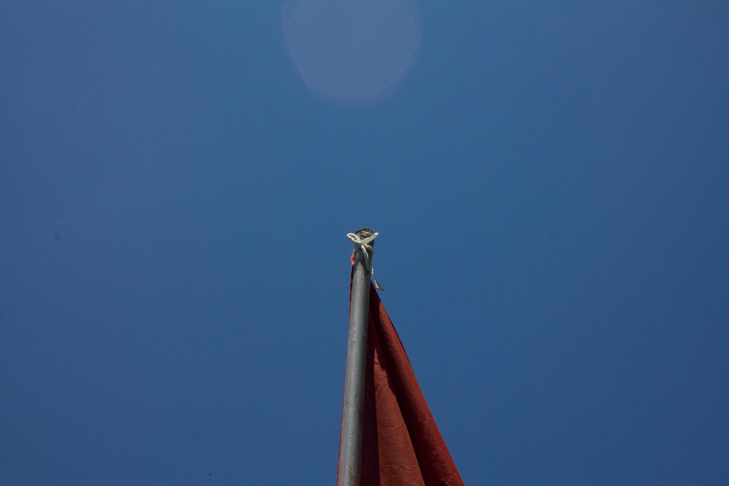 flag on pole with sky background photo