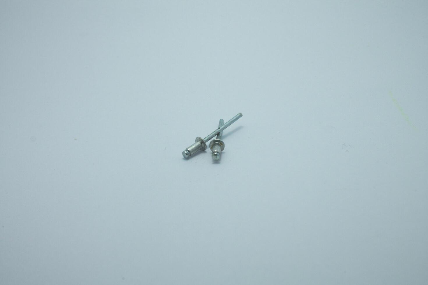 Aluminum rivets on a white background. Sale of rivets and fixing tools. photo