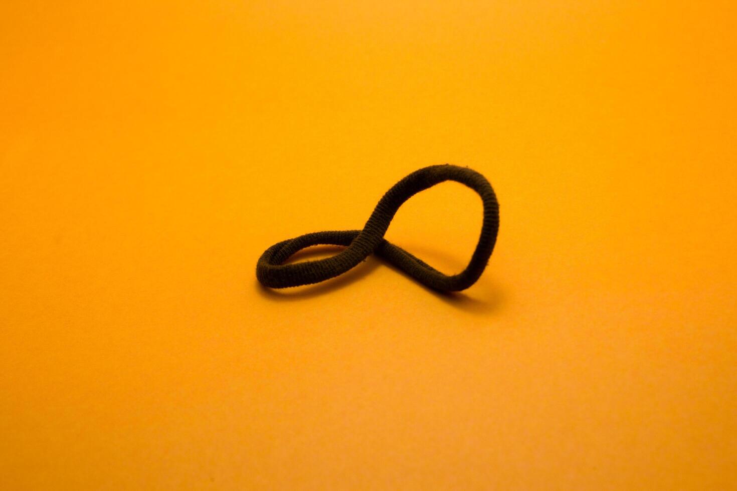 rubber hair tie isolated on yellow background photo