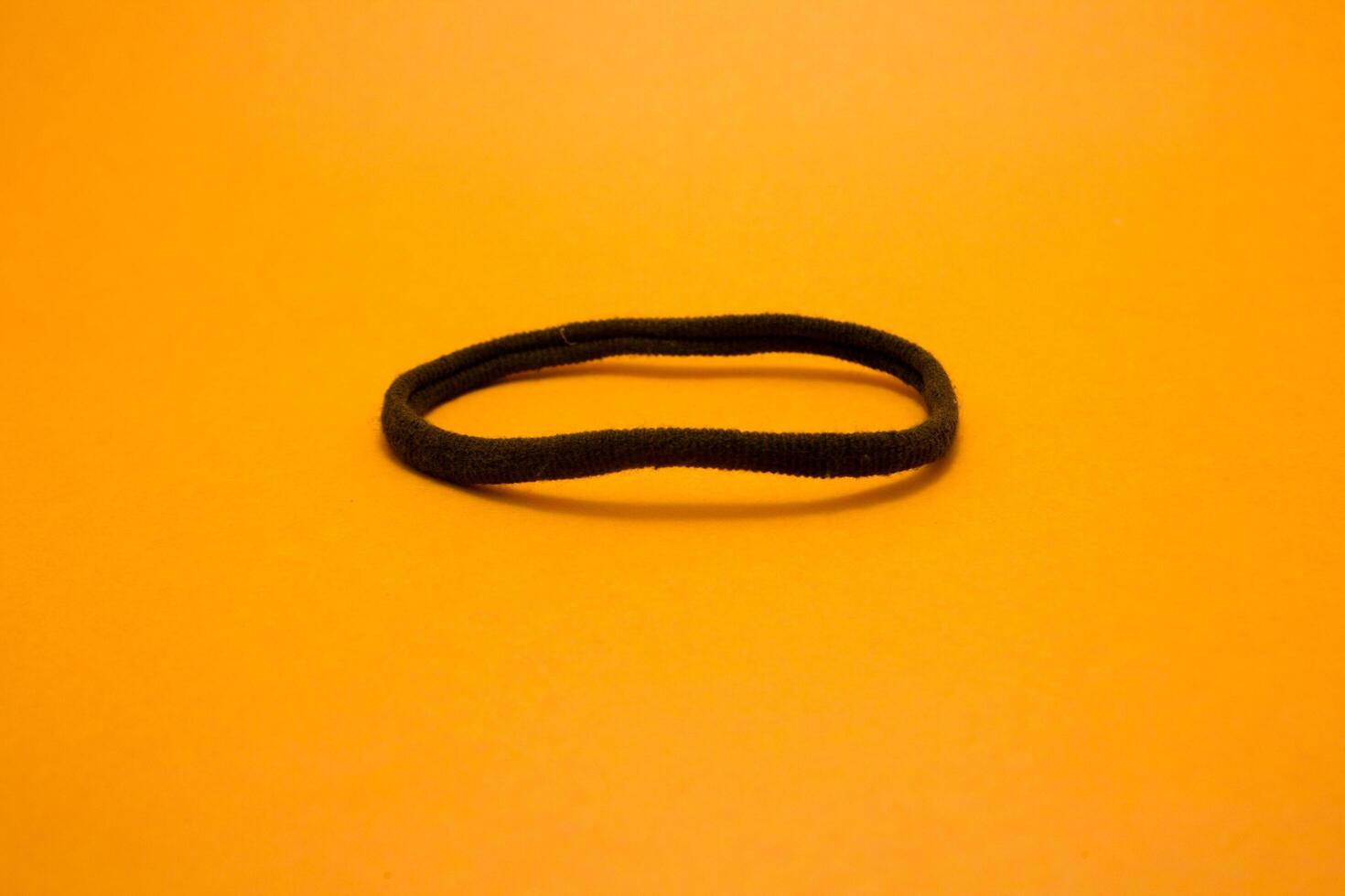 rubber hair tie isolated on yellow background photo