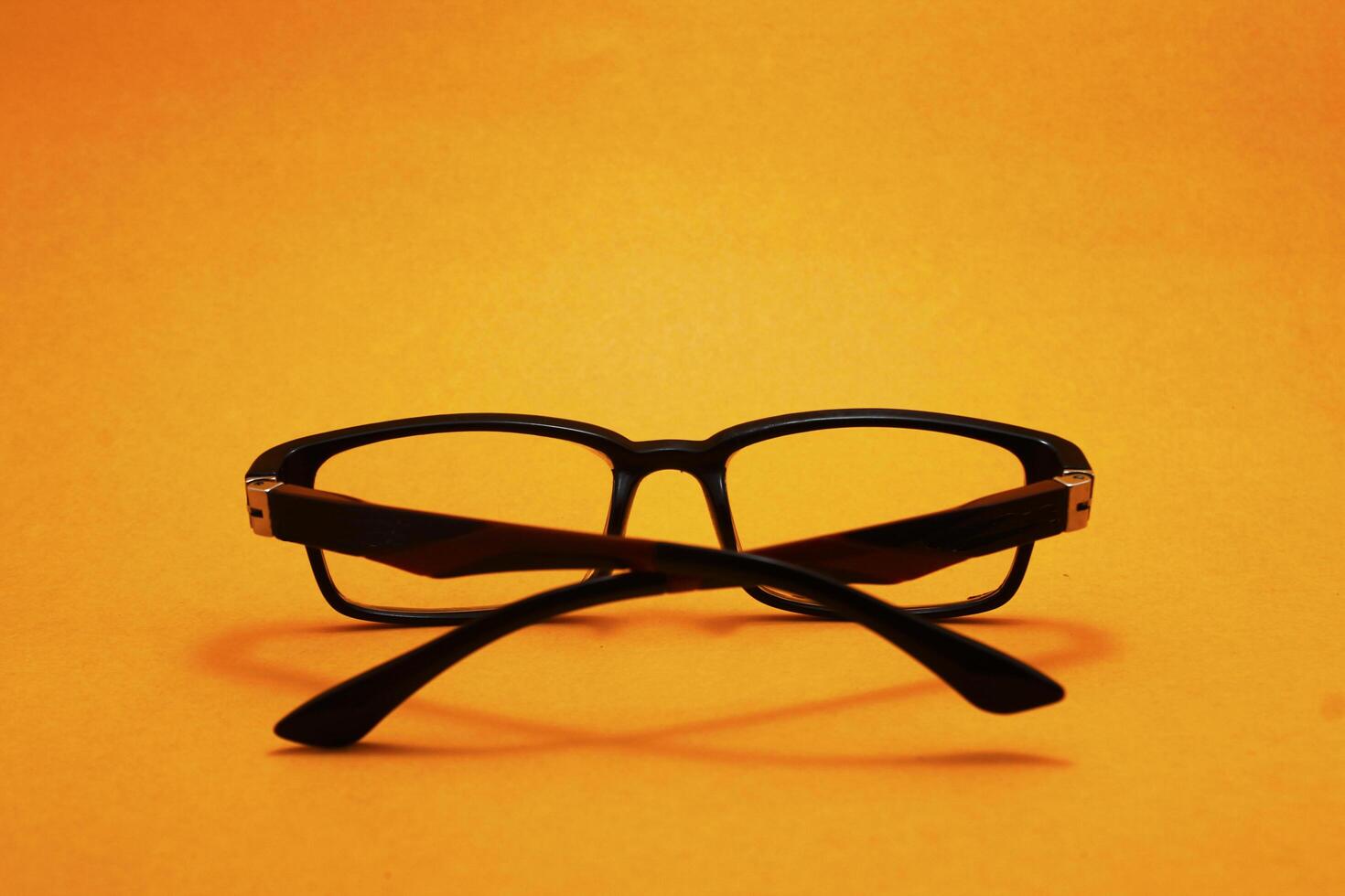 a pair of glasses isolated on yellow background photo