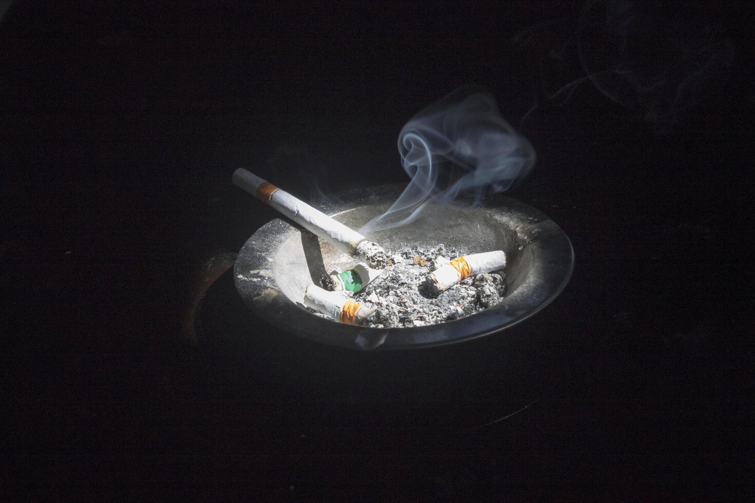 a cigarette on the ashtray photo
