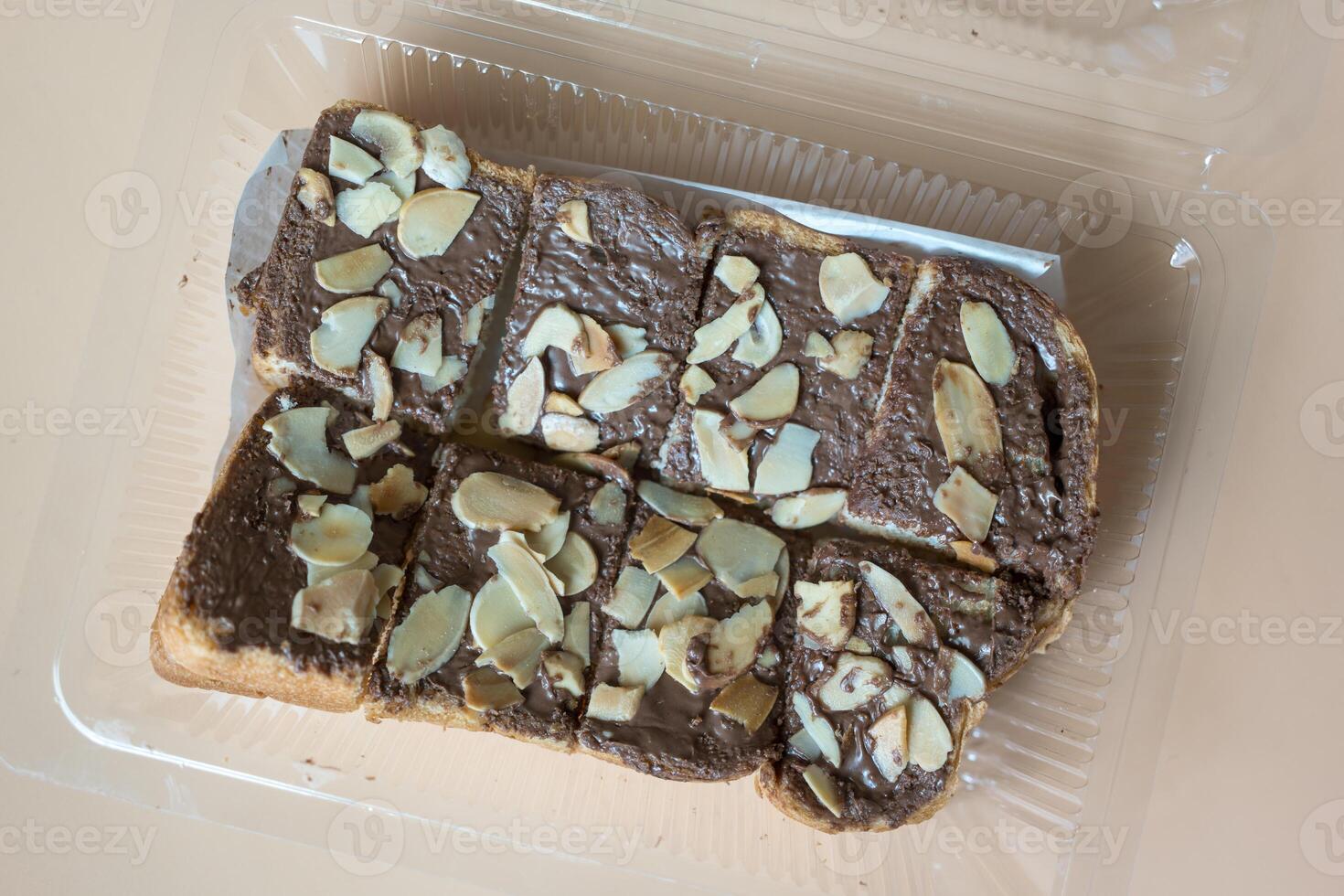 Slices of toast bread with chocolate cream and nuts photo