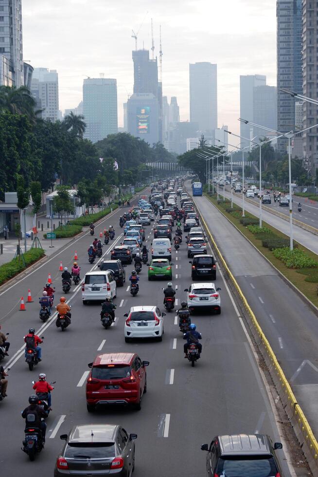 Busy morning in Jakarta, traffic congestion, rush vehicle on weekdays and skyscrapers on main road of business and office centers Jakarta, Indonesia - July 3, 2020 photo